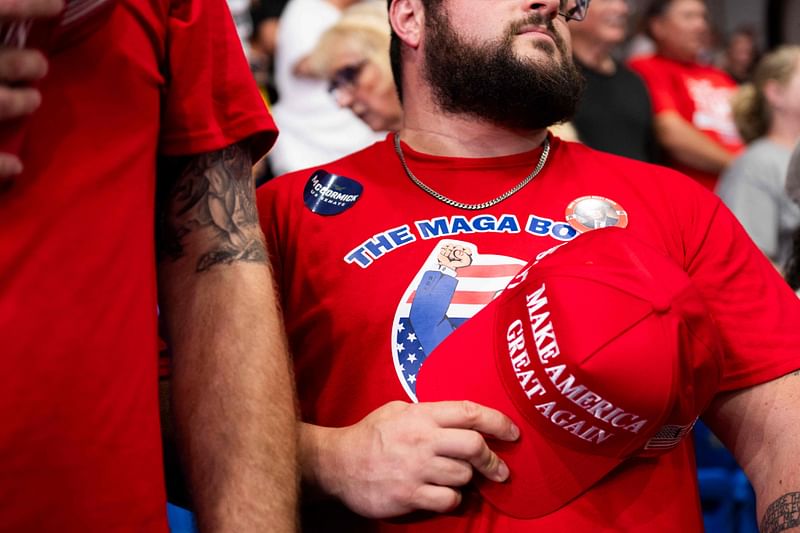 A tattooed Millennial cryptocurrency investor wears a MAGA BOYZ t-shirt during a political rally where former US President and presidential candidate Donald Trump spoke during a campaign stop in the Cambria County War Memorial in Johnstown, Pennsylvania on 30 August 2024